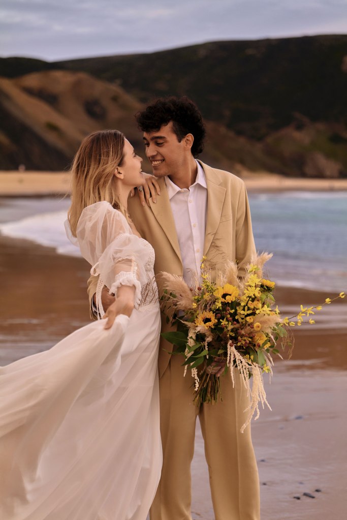 Elopement Portugal Küste – Brautpaar blickt aufs Meer, magische goldene Stunde © Chirlyart